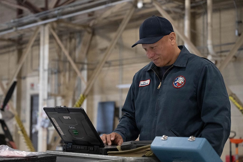 A maintenance directorate engines mechanic types on a laptop at Laughlin Air Force Base, Texas.